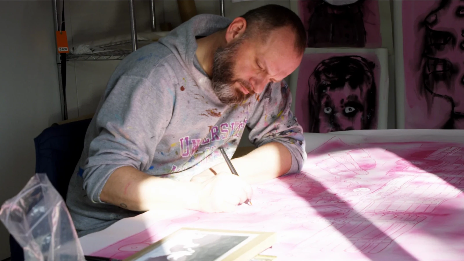 Erik painting at his desk